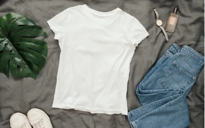 Picture of a white tshirt on a bed alongside other things for a piece on how to plop hair
