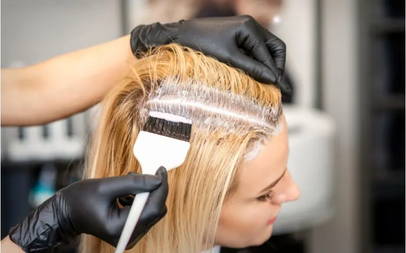 Woman getting the roots of her hair bleached