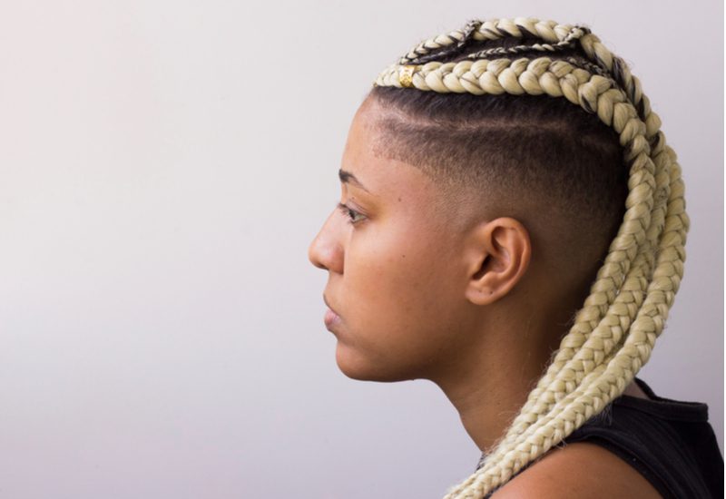 For a piece on tribal braids, a woman with dutch braids that are dyed blonde and pulled back with a shaved side