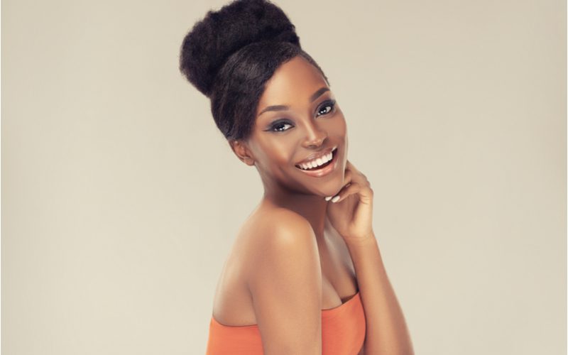 Featured black hairstyle featuring an Updo With Side Bangs