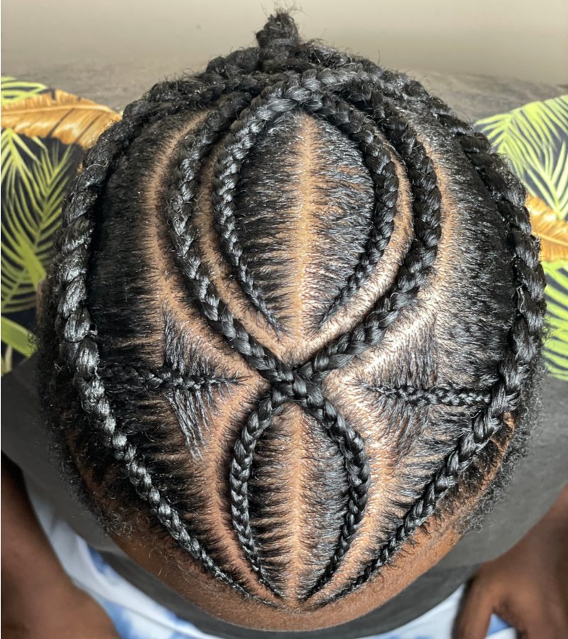 Braids for men inspiration on a guy with a spider or x looking braids on the top of his head as viewed from the top