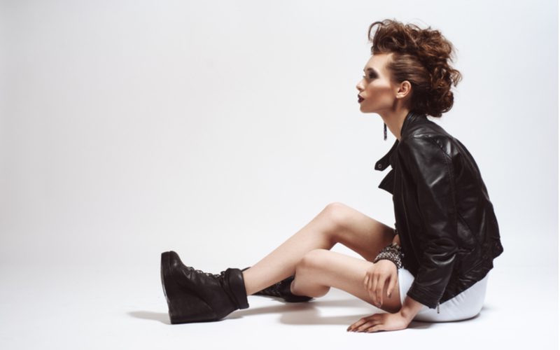 Punk hairstyle titled Rowdy Ringlets on a woman in a white skirt and a black leather jacket