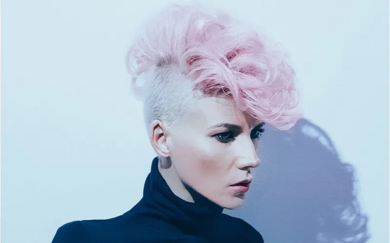 For a piece on punk hairstyles, a woman with Bubblegum Curls looks left in a side profile image