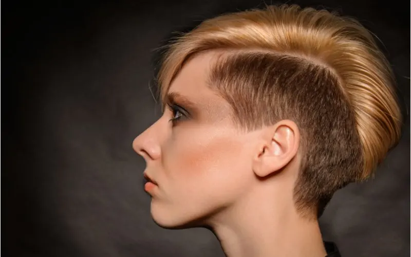 Rocker vibes asymmetrical bob hairstyle on a woman with a partly shaved head
