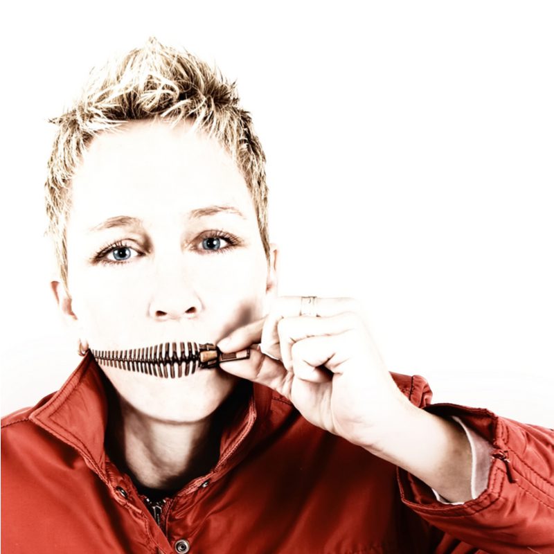 Cropped Style Faux Hawk worn by a woman holding a zipper up to her mouth