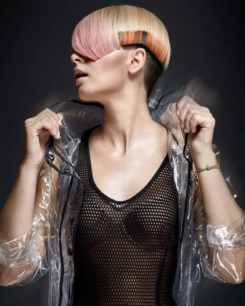 Short Blunt Bob Hairstyle With an Undercut  in an edgy artistic image of a woman in a fishnet shirt with a red bra