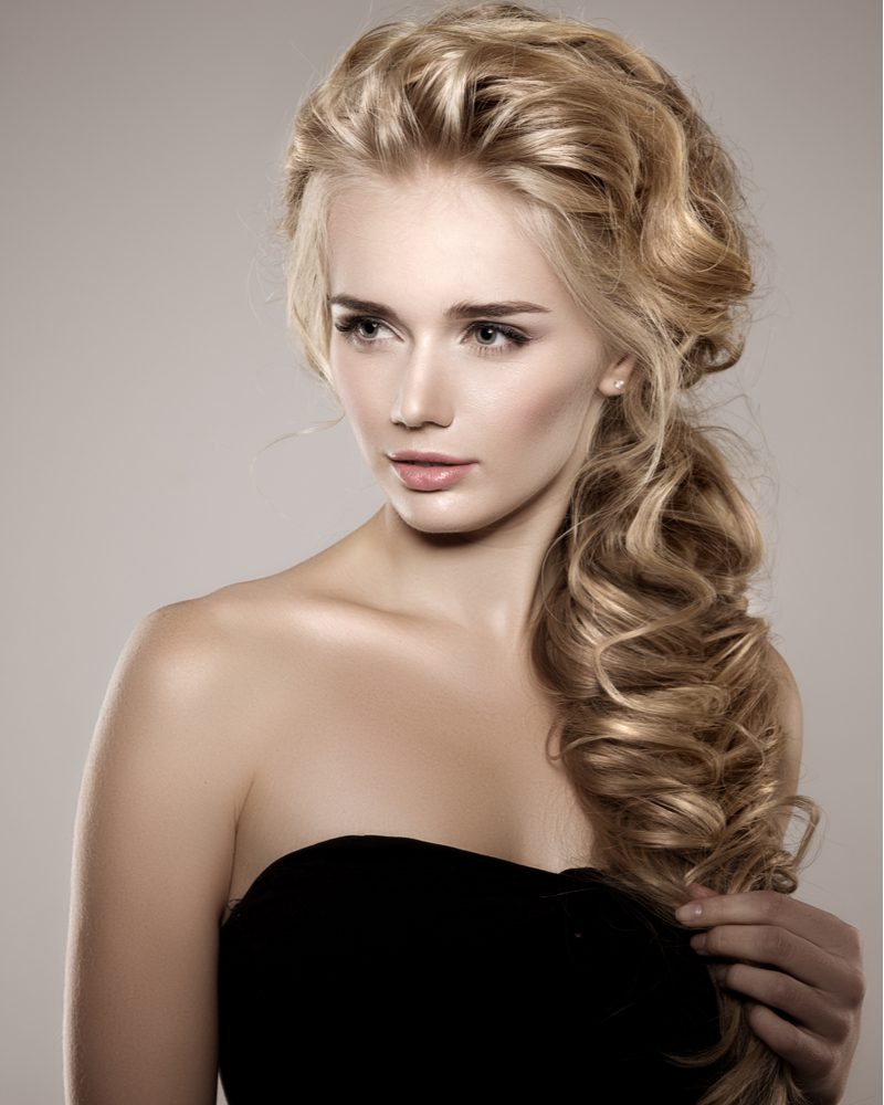 Voluminous Long Braid on a woman in a strapless dress for a piece on easy updos