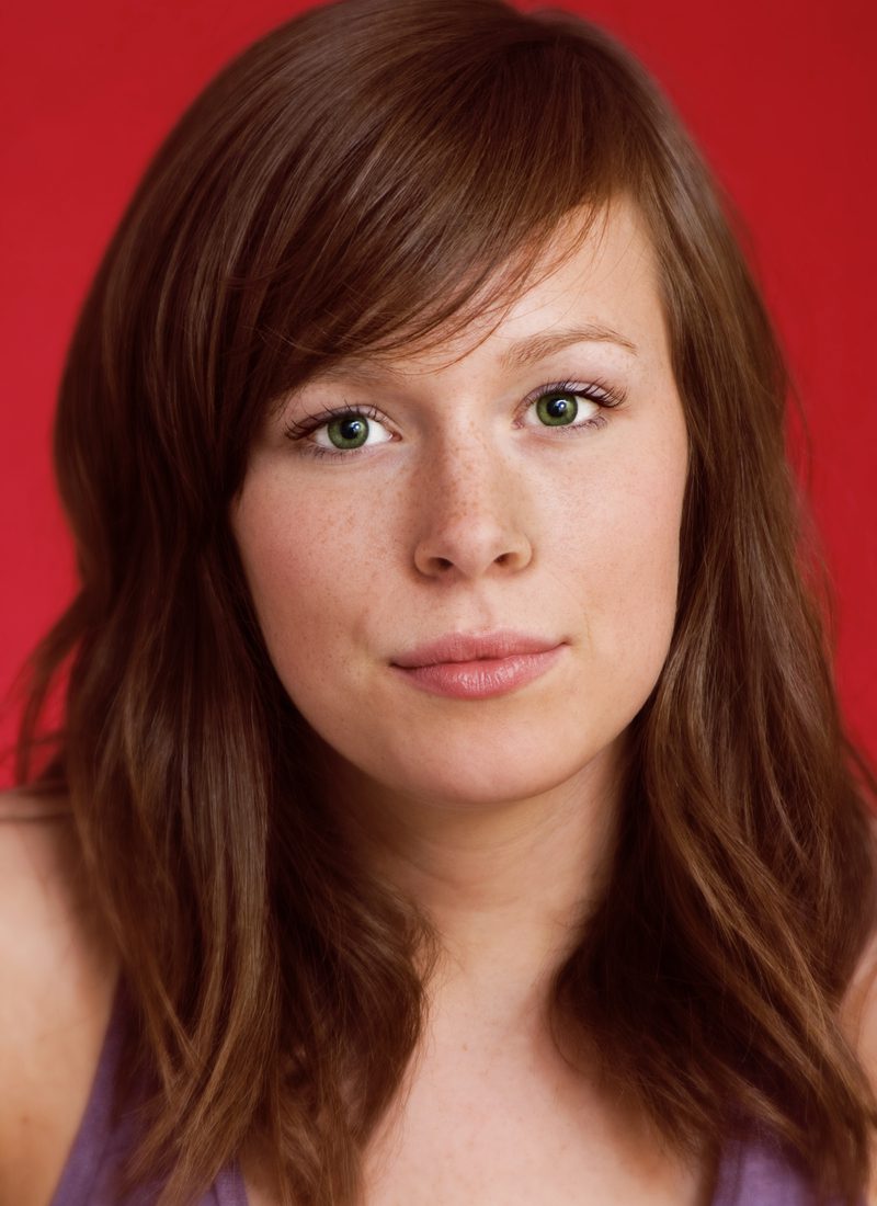 Medium-Long Smooth Auburn Shag haircut on a light brown haired woman with freckles