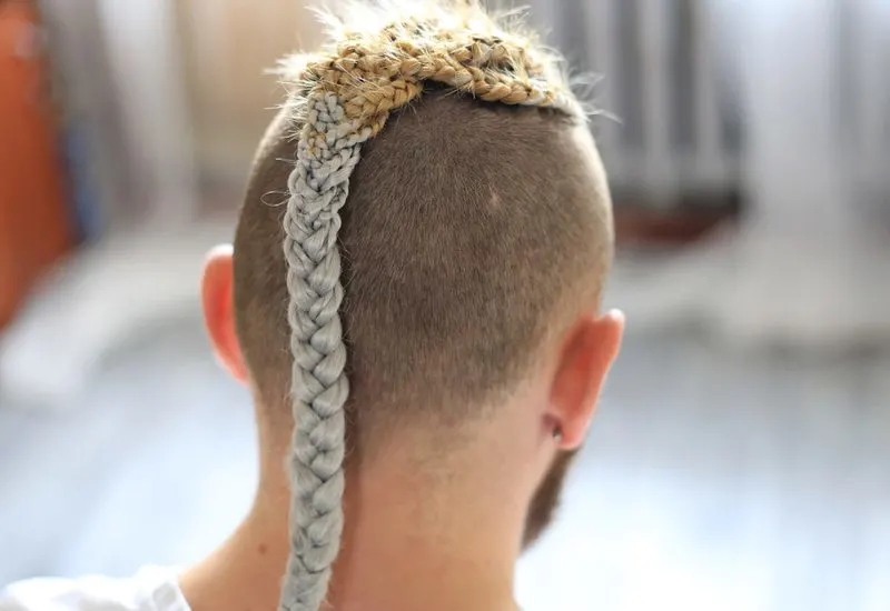 Behind image of a male with viking braids for men with a nordic blonde rat tail