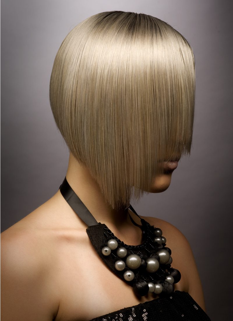 Angled Bob With Face-Framing Layers on a gal with blonde hair wearing a fancy black dress