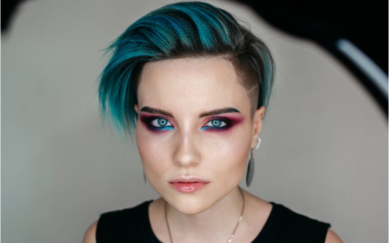 Sexy woman with a Metallic Teal Angled Undercut punk hairstyle