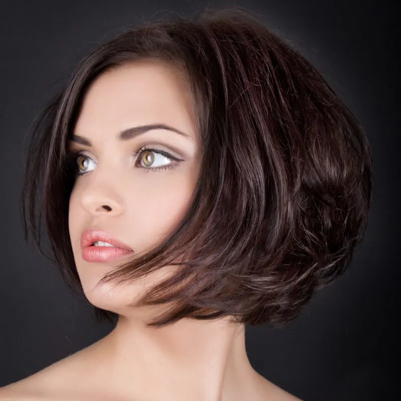 Layered and stacked bob haircut on a woman with fair skin and big brown eyes