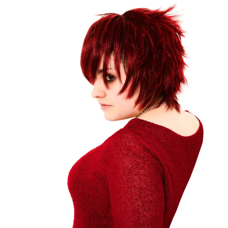 Traditional Sharon Osborne shag haircut on a woman in a red sweater dress