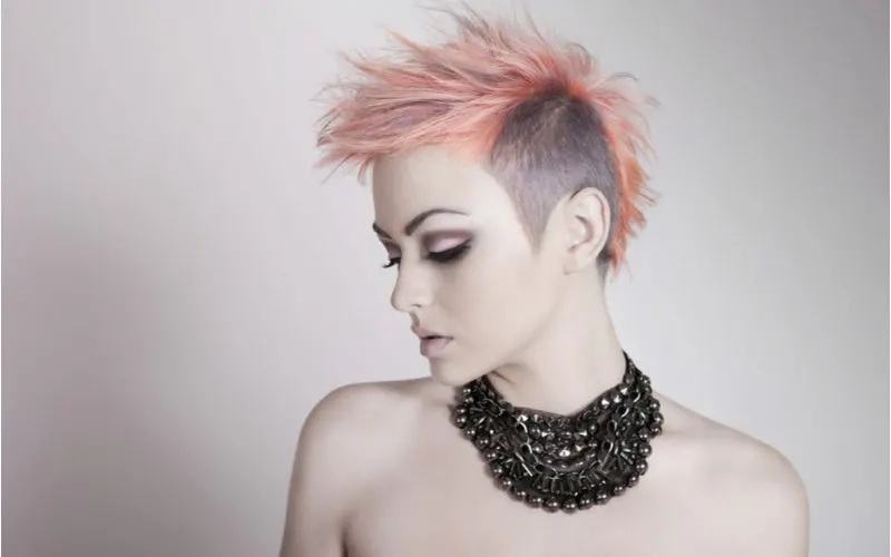 Punk hairstyle titled Hi-Contrast Punky Pastels on a woman in only a beaded necklace