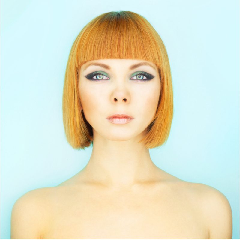 Bold and Bright Copper Bob With Bangs on a fair-skinned woman