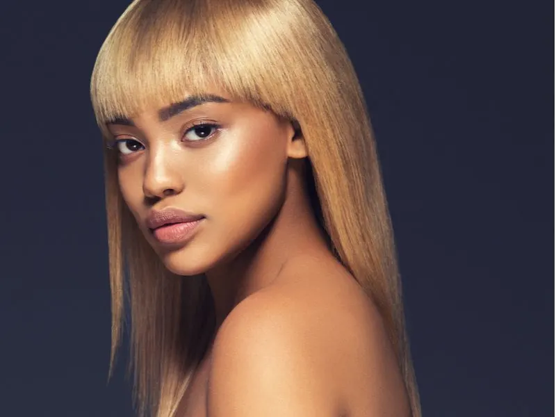 Warm Honey Blonde hair color on a woman with brown skin