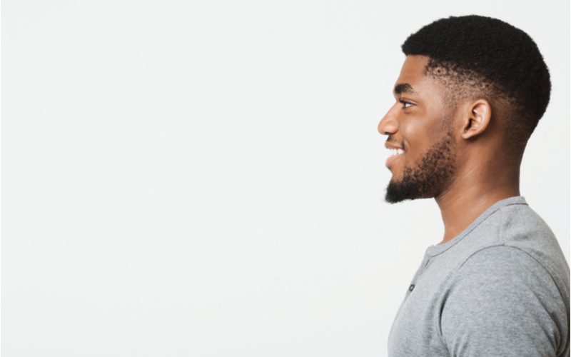 Side profile of a black man with a Drop Bald Fade With Line Up