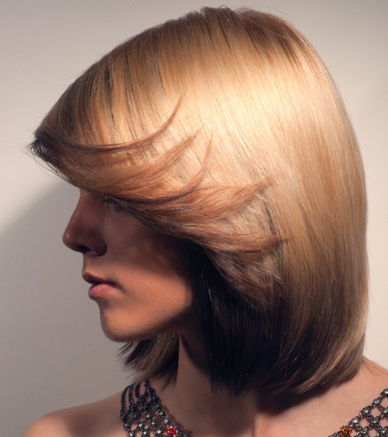 Image for a piece on underdye hair, a woman rocking a Caramel Strawberry Blonde Over Black style
