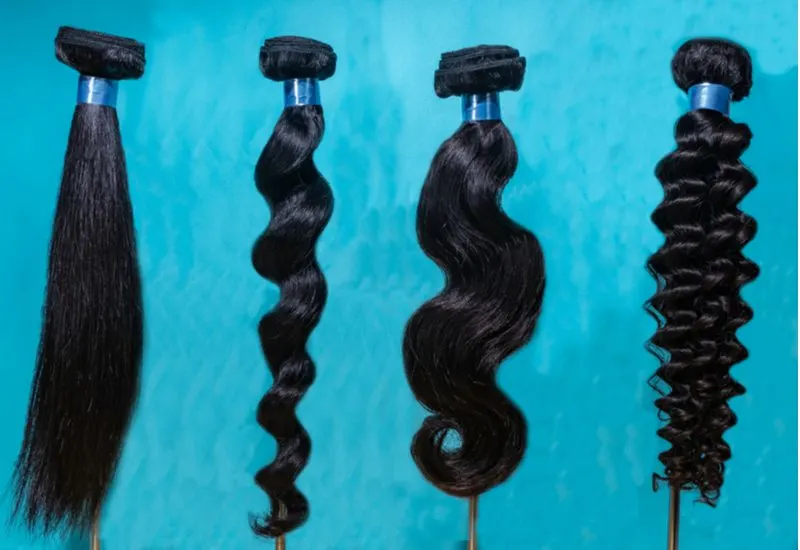 For a section on remy hair vs virgin hair (and to help answer what is virgin hair), a bunch of this type of hair sits on a blue table