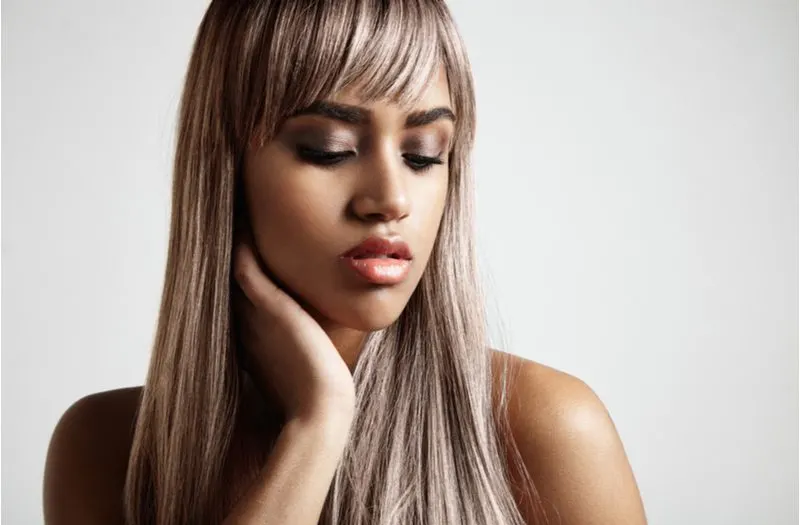 As An Example of hair color for brown skin, a black woman wears Silvery Ash Brown hair