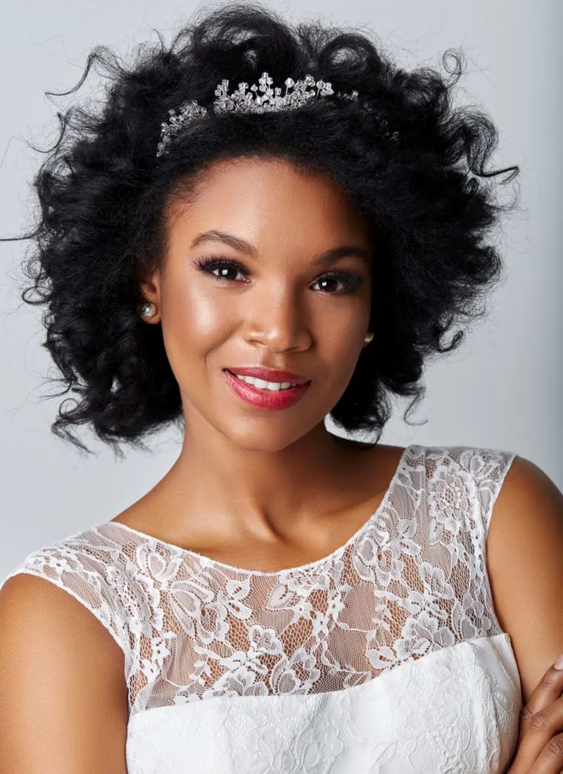 African American bride wearing a hairstyle that features Soft, Loose Ringlets With Bridal Crown