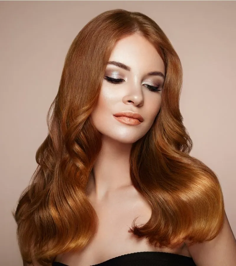Coppery-Golden Auburn hair on a woman with fair skin and a relaxed look on her face