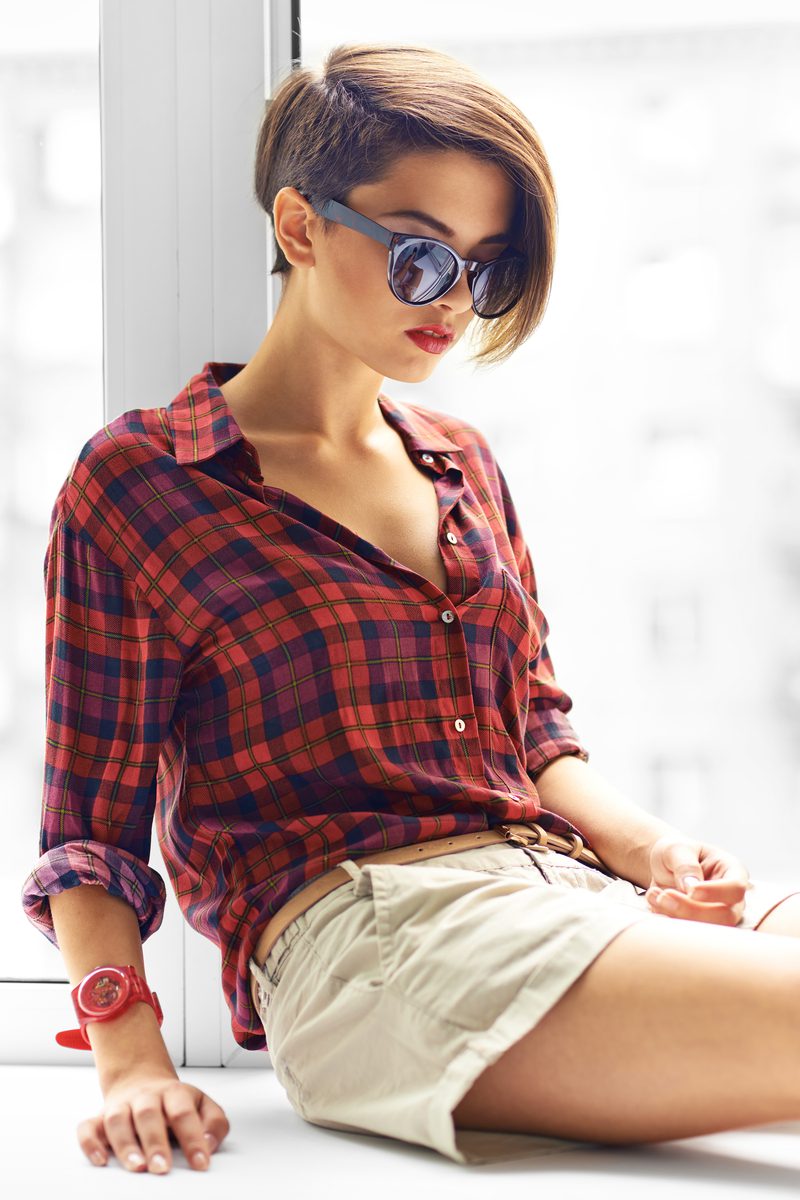 Asymmetrical Bob With Shaved Side on a woman in a red and black plaid shirt