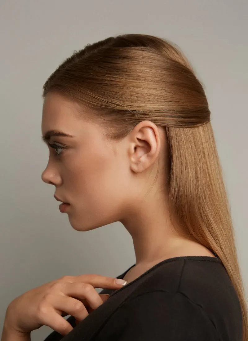 Sleek and Straight Half-Updo listed as an easy hairstyle on a woman in a side-profile image