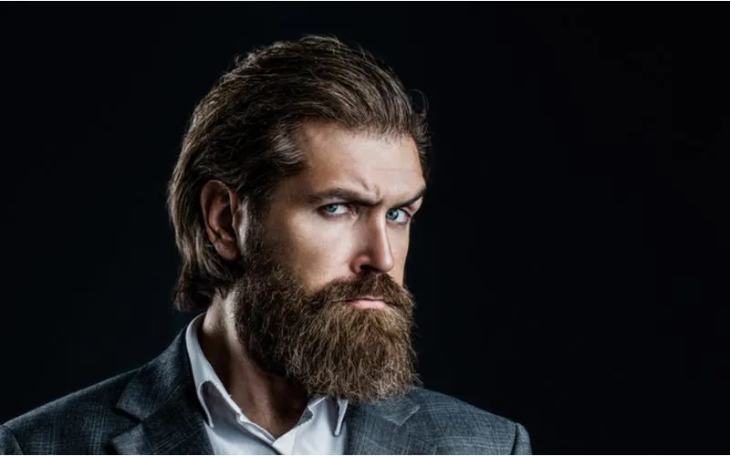 Older man with long hair styled in the Slicked Back Length With Full Beard look