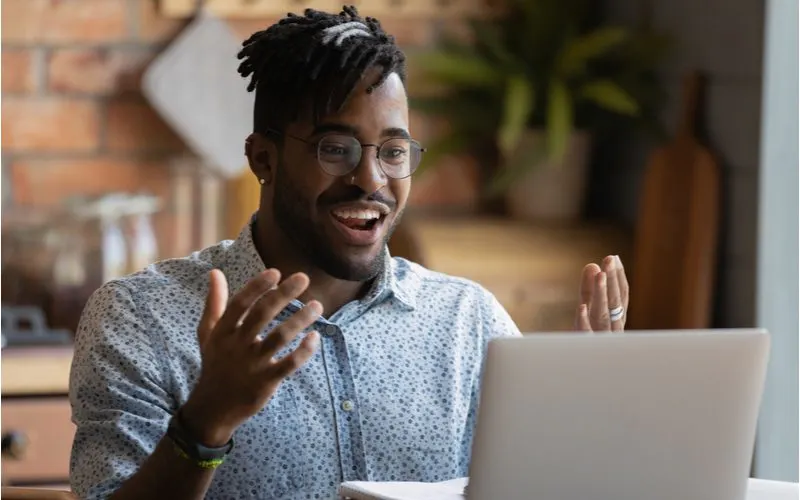 Dreadlock fade hairstyle on a black man sitting at a computer
