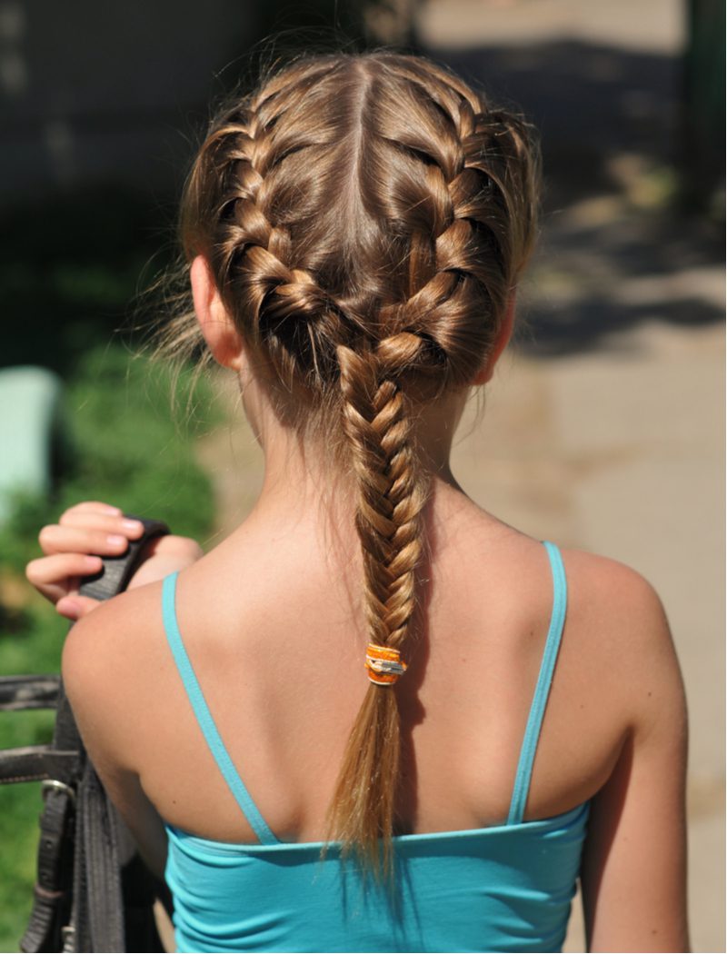 Girl wearing no-heat rope braids for a piece on heatless curls