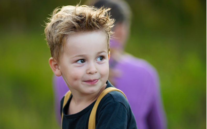 Boy with messy hair styled in the Styled-Up Taper With Long Bangs look