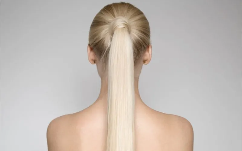 Mid Wrapped Ponytail on a woman in a grey studio