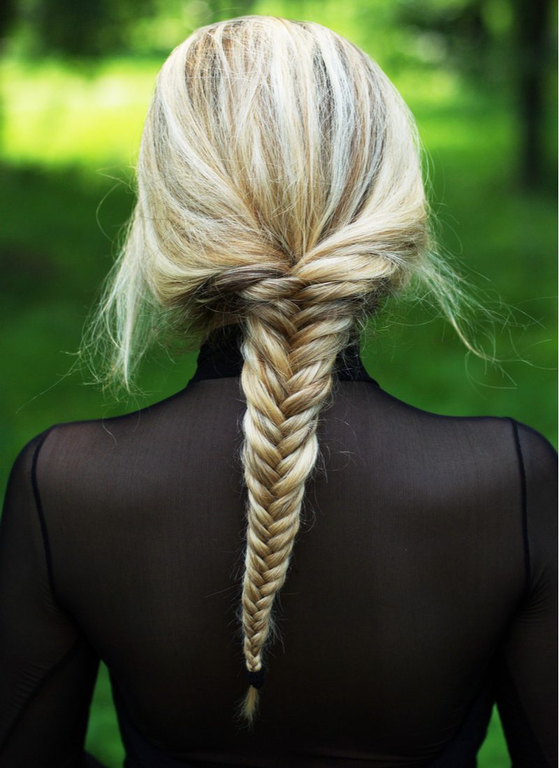 Sophisticated Fishtail Braid on a woman in a black sheer dress standing outside
