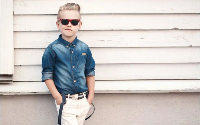 Greaser Pompadour Fade (a popular little boy haircut) worn by a little boy in a jean jacket with his hands in his pockets