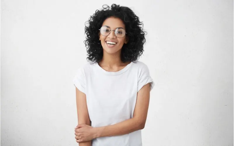 Natural Curls With All-Around Volume, a featured haircut for round faced women