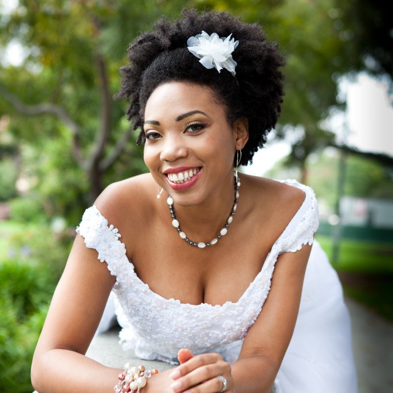 African American bride hairstyle titled Natural Coils With Floral Headband Accent