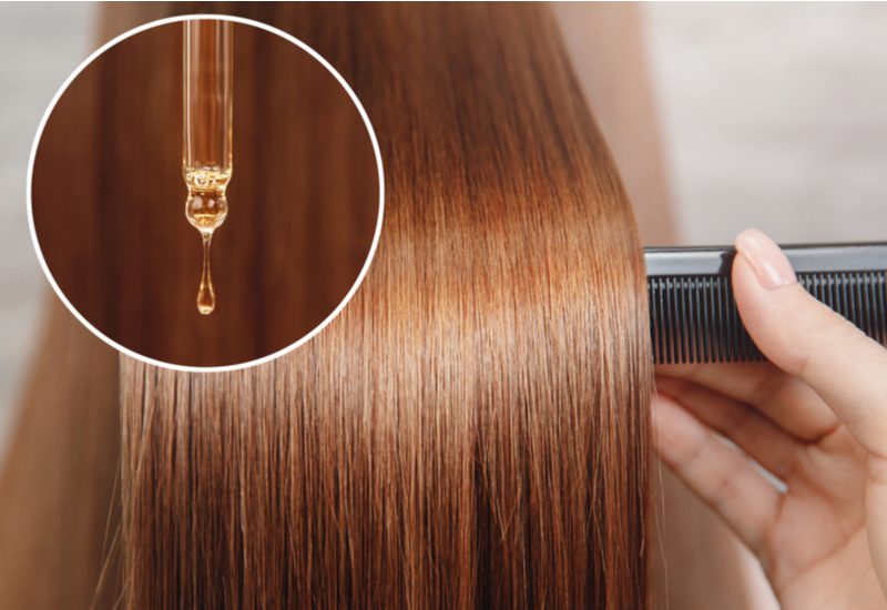 Person using oils for hair growth in a closeup image
