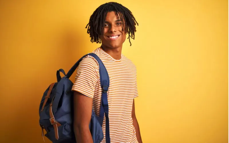 Short Micro Locs on a guy with a backpack wearing the natural hairstyle