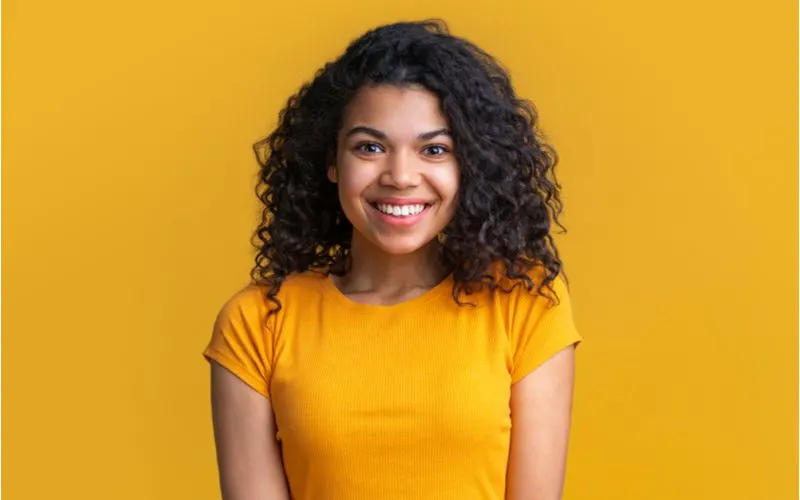 Pretty lightskinned woman in a yellow shirt helping illustrate the question, 