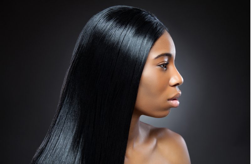 Black woman with a silky smooth texture hairpiece to help illustrate the styles of wigs for black women
