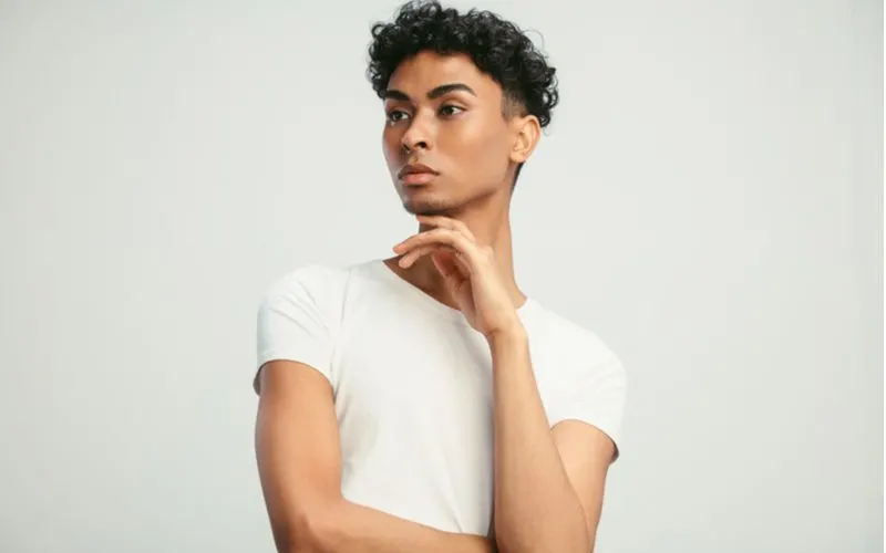 Androgynous hairstyle featuring a Curly Taper With Burst Fade