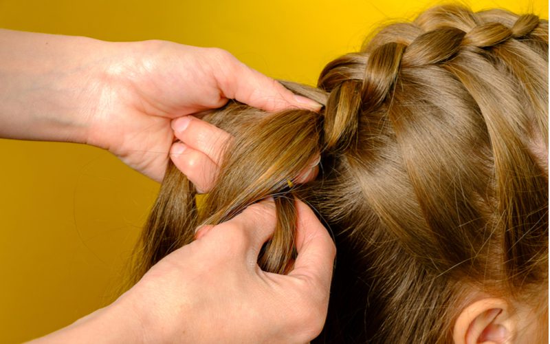 Woman with a French Braid in the process of being done