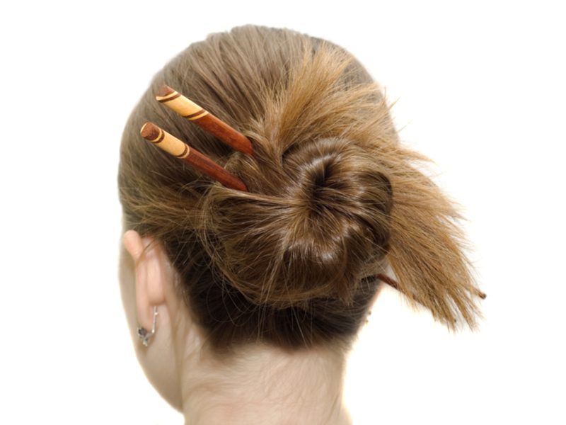 Low Coiled Messy Bun With Twin Hair Sticks