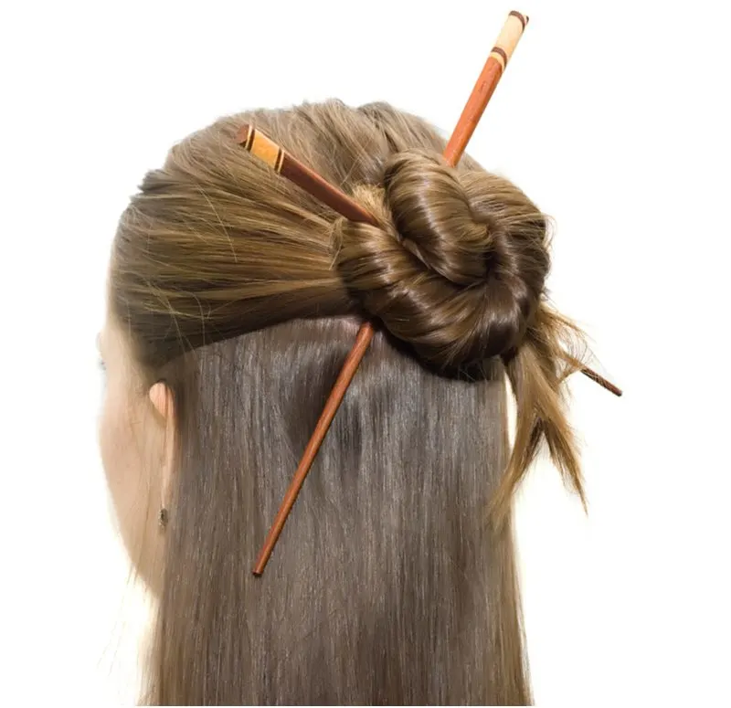 Coiled Bun Half-Up Knot with hair sticks in it