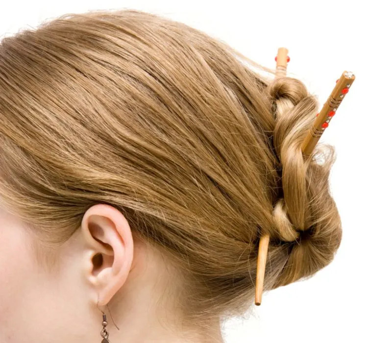 Hair sticks in the back of a woman's bun