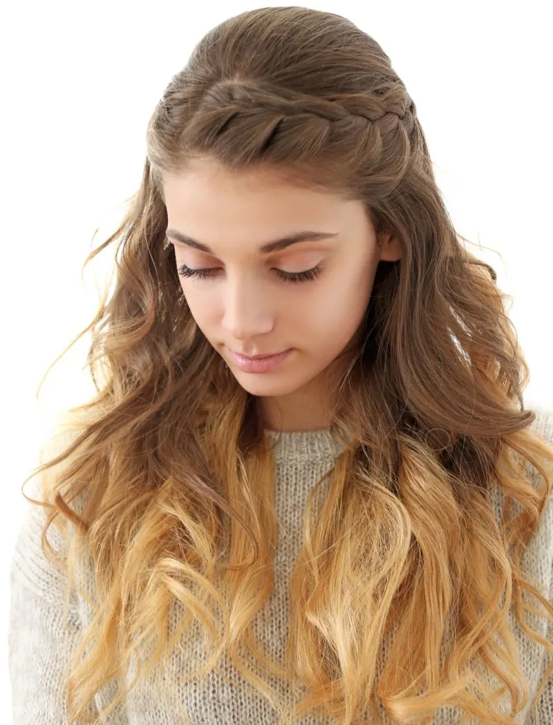 Half-Crown French Braid on a woman in a studio wearing a grey sweater