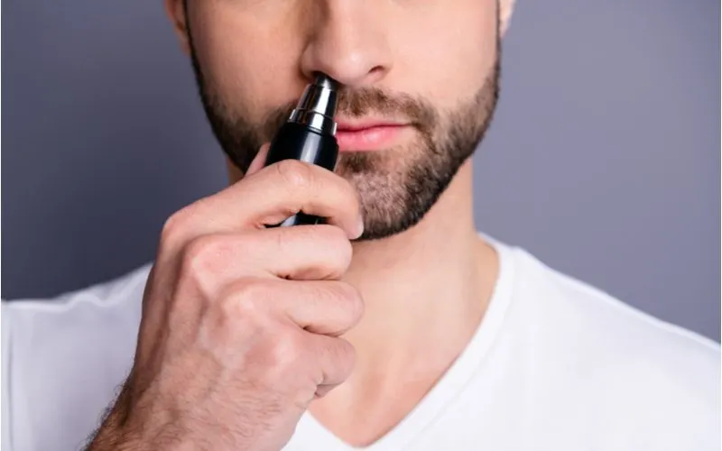 Guy trimming his nose with one of the best body trimmers for men