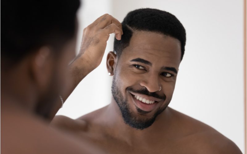 Black guy using the best hair gel for black hair