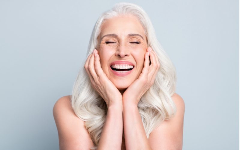 Woman smiling because she just used the best conditioner for gray hair